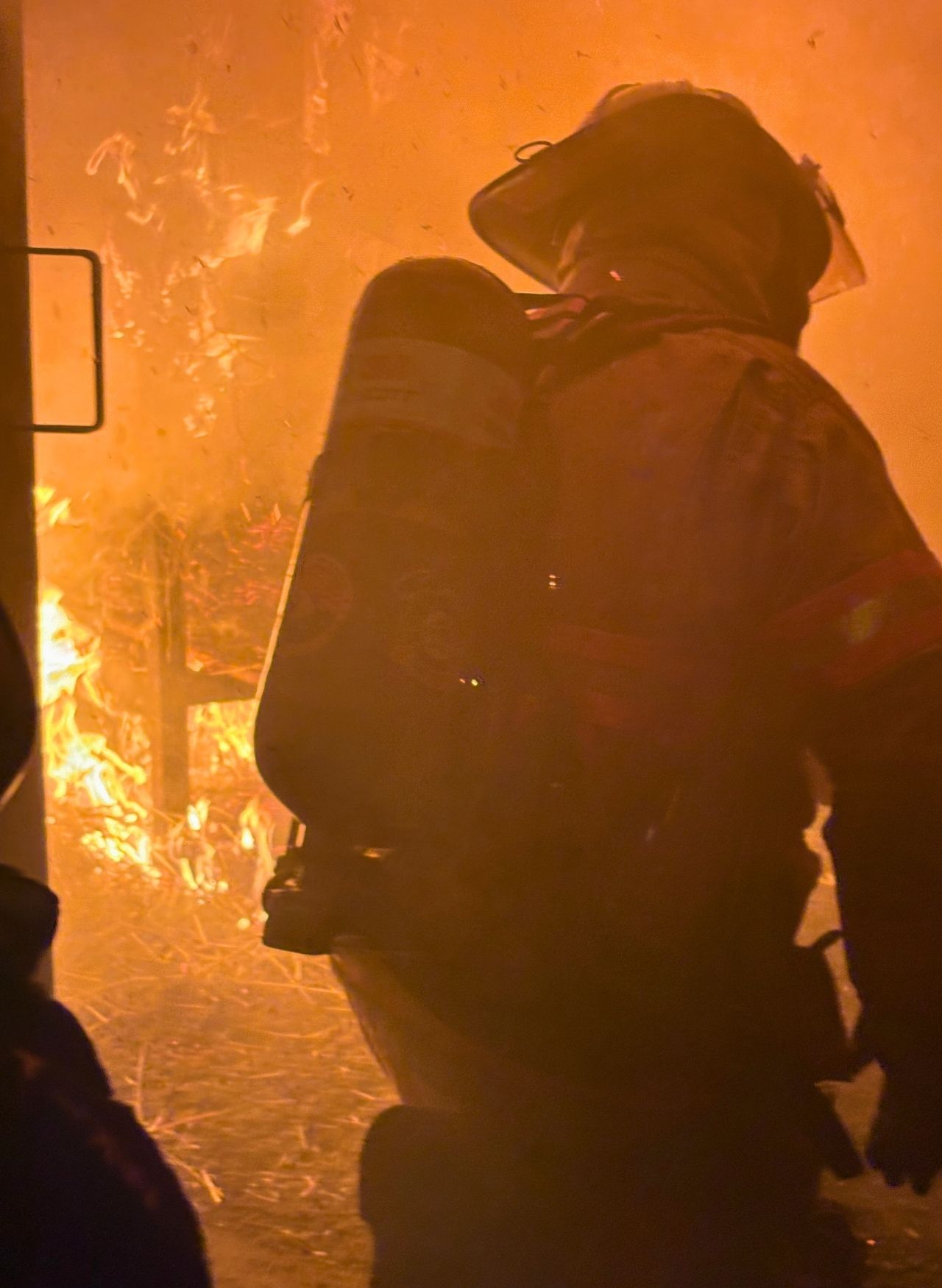 Firefighter wearing Ricochet PFAS-free turnout gear during live fire training for enhanced safety and mobility.